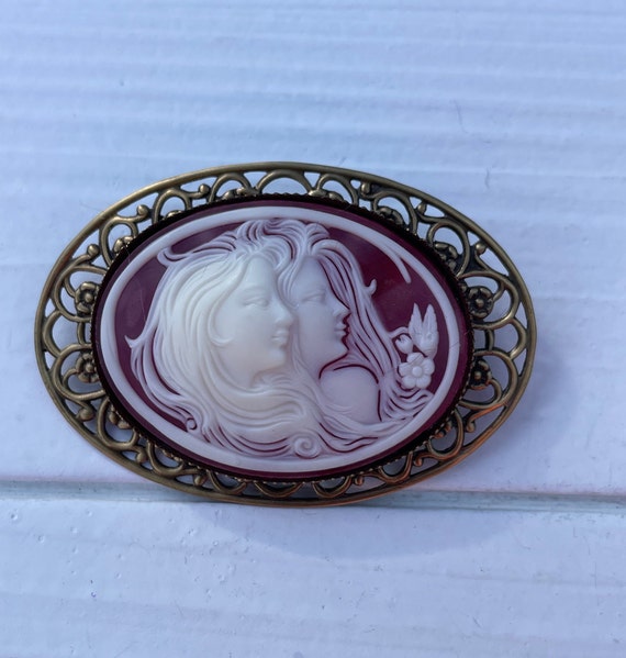 Vintage two women and rose cameo brooch.