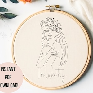 May include: An embroidery hoop with a line drawing of a woman wearing a floral crown. The text "I'm Worthy" is below the drawing. The words "INSTANT PDF DOWNLOAD!" are on the left side.