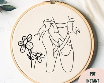 May include: A black and white line drawing of ballet shoes with a bow on top, and two small flowers on a stem. The drawing is on a beige background.