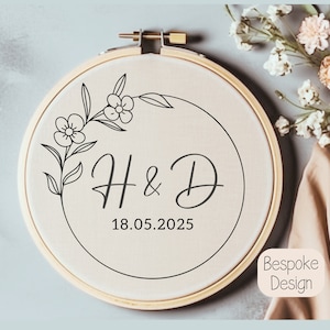 May include: A white embroidery hoop with a floral design and the initials "H & D" and the date "18.05.2025".