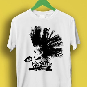 May include: White t-shirt with a black and white graphic print of a woman with a mohawk and the text "The Distillers City of Angels".