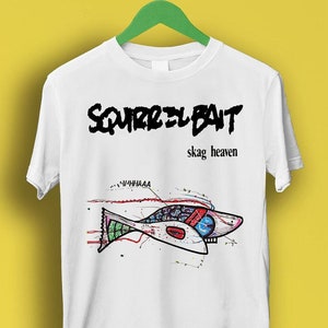 May include: White t-shirt featuring a black graphic of the band "Squirrel Bait" and the text "skag heaven". The graphic also includes a colourful fish with a red, blue and green design.
