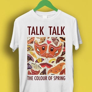 Peut inclure: T-shirt blanc avec un motif de papillon coloré et le texte "TALK TALK THE COLOUR OF SPRING".