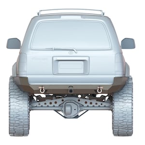 Puede incluir: Un Toyota 4Runner blanco con un portaequipajes en el techo y un parachoques trasero con un enganche de remolque. El vehículo está sobre neumáticos grandes.