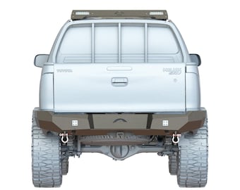 May include: A white Toyota Hilux SRV pickup truck with a roof rack and a rear bumper with tow hooks. The truck has a silver bumper and a black rear bumper.