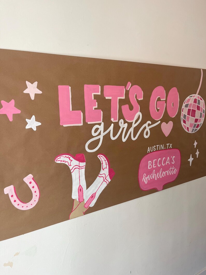 May include: A brown paper banner featuring the pink text LET'S GO girls, a disco ball, stars, a horseshoe, and white cowboy boots with pink accents. A pink speech bubble contains the text AUSTIN, TX BECCA'S bachelorette in white lettering.