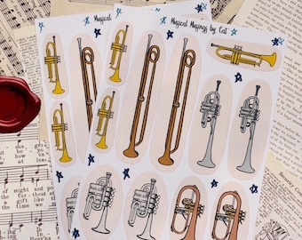 May include: A sheet of stickers featuring illustrations of various brass musical instruments, including trumpets, trombones, and a French horn. The stickers are on a light pink background with blue stars and the text "Musical Musings by Cat".