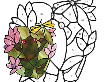 May include: A stained glass pattern of a frog sitting on a lily pad with a dragonfly and butterfly. The pattern is labelled "Frog" and is 7 inches by 8 inches. The pattern is numbered for easy assembly.