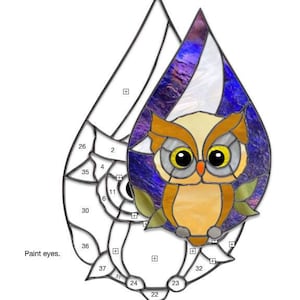 May include: A stained glass pattern of an owl in a teardrop shape with the words "Owl and Moon Teardrop" at the top and "Down East Stained Glass" at the bottom. The pattern is labeled with numbers for each piece of glass. The pattern is 5 inches by 8 1/4 inches.