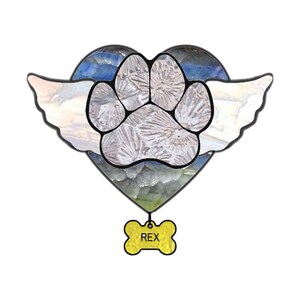 May include: A stained glass heart with a paw print in the center and angel wings on either side. A yellow bone tag with the name "REX" hangs from the bottom of the heart.