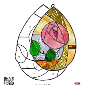 May include: A stained glass teardrop-shaped panel featuring a pink rose with green leaves and a yellow and orange background. The panel is 5 1/2 inches by 7 1/2 inches.