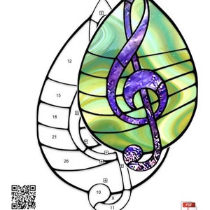 May include: A stained glass pattern for a teardrop-shaped treble clef. The pattern is outlined in black and includes numbered sections for cutting and assembling the glass. The finished piece measures 5 1/2 inches by 8 3/4 inches.