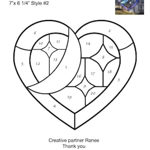 May include: A black and white line drawing of a heart-shaped stained glass pattern with 20 numbered sections. The title "Moon & Stars" and the text "7"x 6 1/4" Style #2" are at the top of the image.