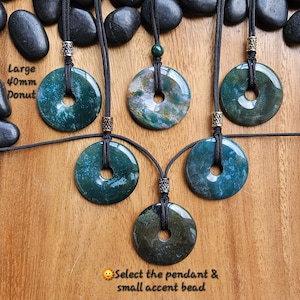 May include: Five green agate donut pendants on black cords with silver and gold accents. The pendants are different sizes and have unique patterns. The text "Large 40mm Donut" is visible in the image.