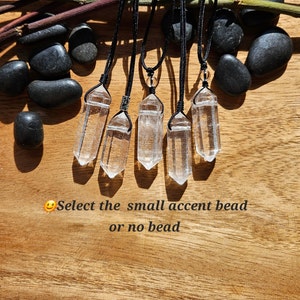May include: Six clear quartz crystal pendants on black cords with a small accent bead option.  Select the small accent bead or no bead.