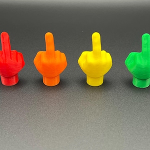 May include: Four small figurines of a middle finger, each painted a different color: red, orange, yellow, and green.