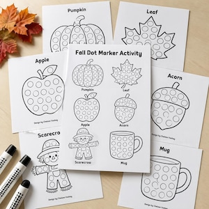 May include: A collection of white paper sheets featuring black line art for a Fall Dot Marker Activity. The pages display illustrations of a pumpkin, leaf, apple, acorn, scarecrow, and mug, each with circular outlines for dot markers.