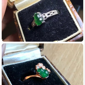 May include: Two jade rings in their boxes. The top ring is silver with a green jade stone and white diamonds. The bottom ring is gold with a green jade stone and white diamonds.