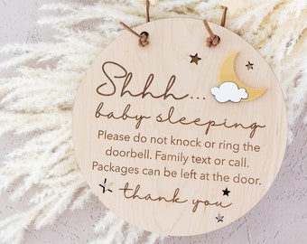 May include: A wooden sign with a yellow moon and cloud design, reading "Shhh... baby sleeping. Please do not knock or ring the doorbell. Family text or call. Packages can be left at the door. Thank you."