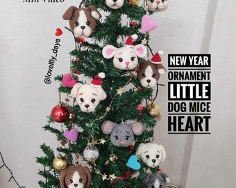 May include: A Christmas tree decorated with crocheted dog and mouse ornaments, hearts, and red and silver baubles. The tree is decorated with a sign that reads "NEW YEAR ORNAMENT LITTLE DOG MICE HEART".