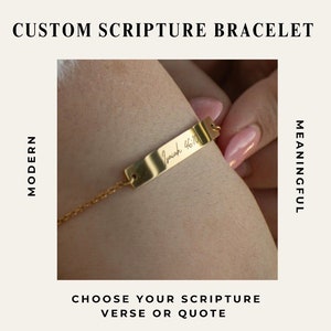 May include: Gold bracelet with a personalised inscription that reads "Isaiah 46:10". The bracelet is on a person's wrist.