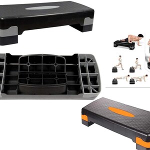 May include: A black and grey adjustable aerobic step platform with a textured surface. The platform has two levels and can be used for a variety of exercises.
