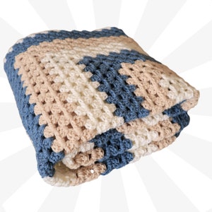 May include: A crocheted baby blanket with a striped pattern in shades of blue, beige, and white.