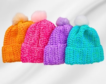 May include: Four crocheted hats with pom-poms in bright colors: orange, pink, purple, and blue.