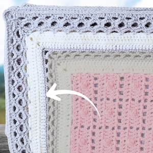 May include: Close-up of a stack of handmade crochet blankets. The blankets feature a variety of textures and colors, including gray, white, and pink. The top blanket has an openwork design, while the others have solid and textured patterns. The blankets are neatly folded.