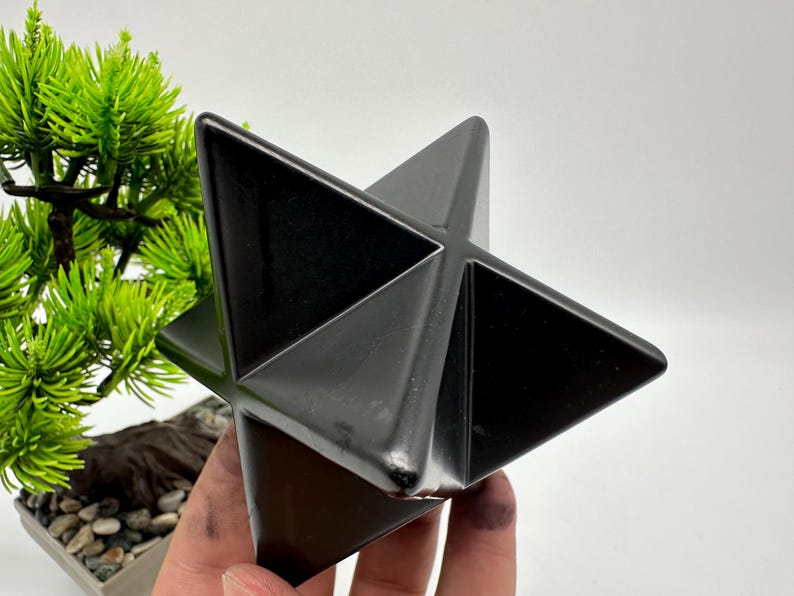 May include: A black obsidian star shaped crystal, also known as a Merkaba, is a geometric shape that is often used in meditation and healing.