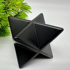 May include: A black obsidian star shaped crystal, also known as a Merkaba, is a geometric shape that is often used in meditation and healing.