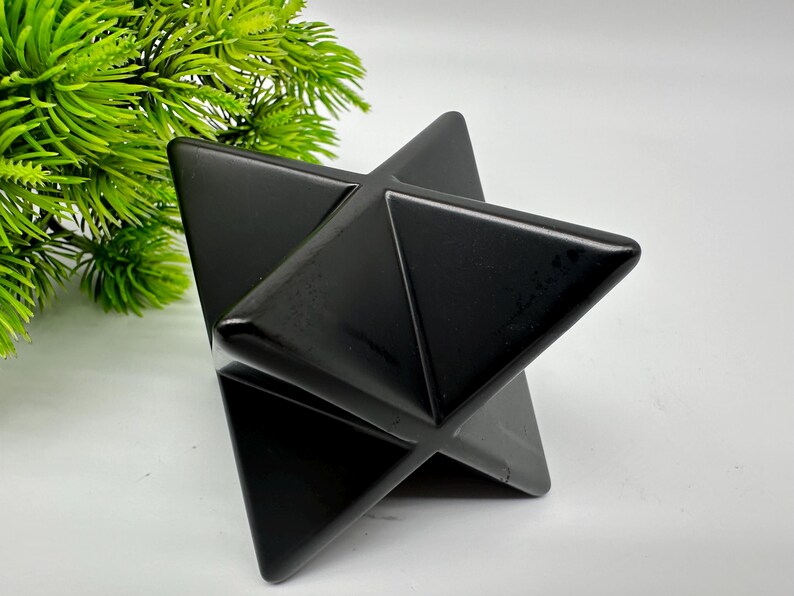 May include: A black obsidian star shaped crystal, also known as a Merkaba, is a geometric shape that is often used in meditation and healing.