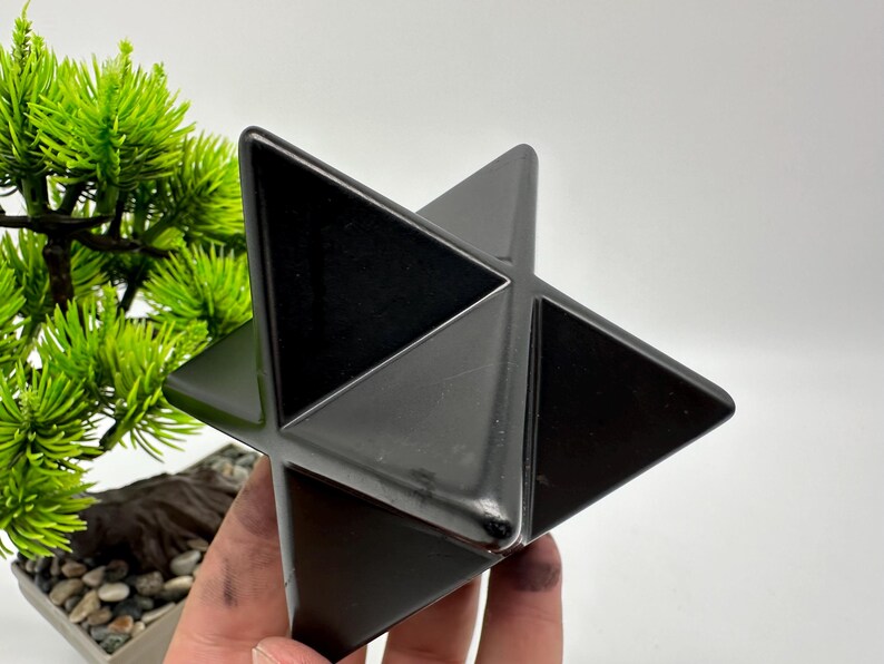 May include: A black obsidian star shaped crystal, also known as a Merkaba, is a geometric shape that is often used in meditation and healing.