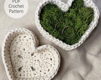 May include: Two crocheted heart-shaped bowls, one filled with green moss and two gold rings, the other empty.  PDF Crochet Pattern.