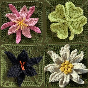 May include: Four crocheted squares featuring floral designs. The squares showcase a pink and yellow flower, a green four-leaf clover, a black flower with orange accents, and a white flower with yellow center, all on green backgrounds.