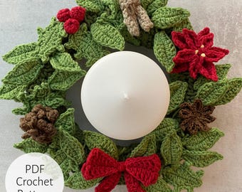 May include: A crochet wreath with green leaves, red poinsettias, brown pine cones, a red bow, and a white candle in the center. The wreath is made with yarn and is a PDF crochet pattern.