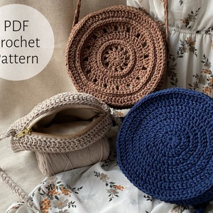 May include: Three crocheted bags, one brown, one beige, and one blue. The bags are round and have a circular pattern. The beige bag has a zipper. The text "PDF Crochet Pattern" is in a white circle on the left side of the image.