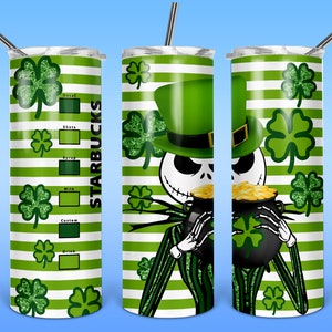 May include: A green and white striped stainless steel tumbler with a green shamrock pattern and a cartoon character holding a pot of gold. The tumbler has the word "STARBUCKS" printed on the side.