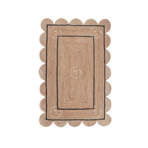 May include: A natural fiber rug with a scalloped edge and a black border. The rug has a woven texture and a rectangular shape.