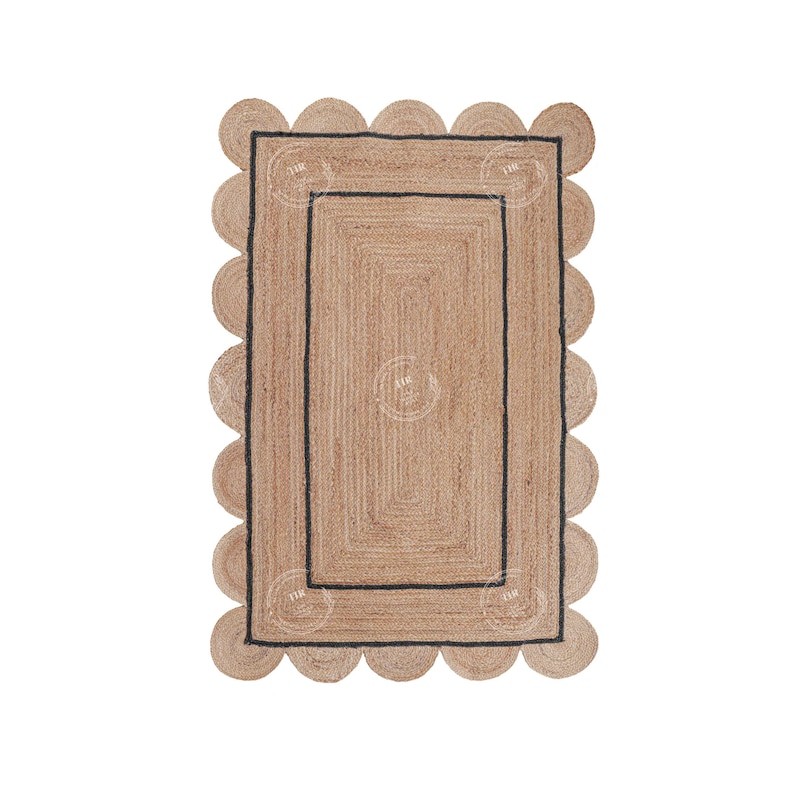 May include: A natural fiber rug with a scalloped edge and a black border. The rug has a woven texture and a rectangular shape.