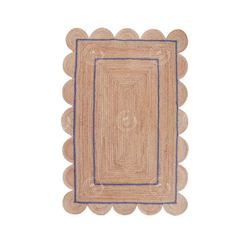 May include: A natural fiber rug with a scalloped border and a blue trim. The rug has a woven texture and is made of jute.