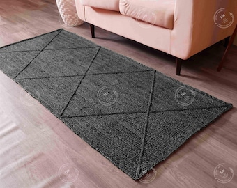 May include: A grey diamond patterned rug with a woven texture. The rug is made of natural fibres and has a subtle sheen.