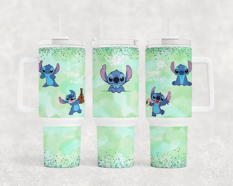 May include: Three stainless steel tumblers with a green and white watercolour background and blue Stitch characters. The tumblers have a white lid and a handle. The text on one tumbler reads "Ohana Family".
