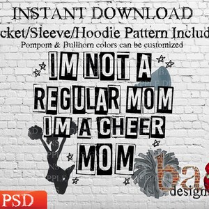 May include: A digital download of a cheer mom design. The design features the text "I'm not a regular mom I'm a cheer mom" in black and white with a cheerleading pom-pom and a red apple with a skull. The design is on a white brick background. The text "ba designs 2023" is in the bottom right corner.