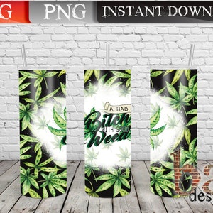 May include: A set of three cylindrical tumblers with a cannabis leaf design. The tumblers feature a black background with green cannabis leaves and the text "A Bad Bitch With Good Weed". Each tumbler has a silver straw.