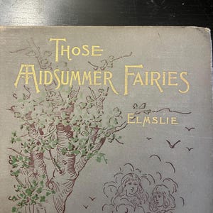 Könnte beinhalten: Ein Vintage-Buchcover mit dem Titel "Those Midsummer Fairies" in goldener Schrift. Das Cover zeigt eine Illustration eines Baumes mit grünen Blättern und zwei Figuren in Wolken, mit dem Namen des Autors "Elmslie".