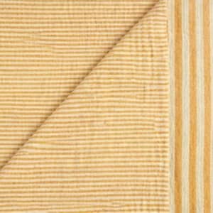 May include: A textile fabric featuring a textured, crinkled surface with a pattern of thin, horizontal mustard yellow and white stripes, transitioning into a border of wider, vertical mustard yellow and white stripes along the right edge.