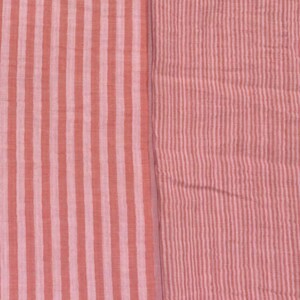 May include: A textile fabric featuring two distinct sections of striped patterns. The left side displays wide vertical stripes in alternating shades of coral and light pink, while the right side shows a finer, denser vertical stripe pattern in similar tones.
