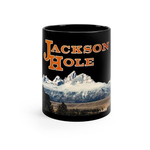 May include: Black coffee mug with a white mountain range and the text "JACKSON HOLE" in orange.