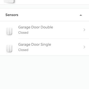 May include: A screenshot of a mobile phone app showing a list of alarm devices. The list includes a base station that is online and two garage door sensors that are closed.
